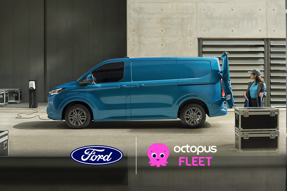 Side view of a Blue Ford E-Transit Custom parked with an open rear door and a person standing nearby.