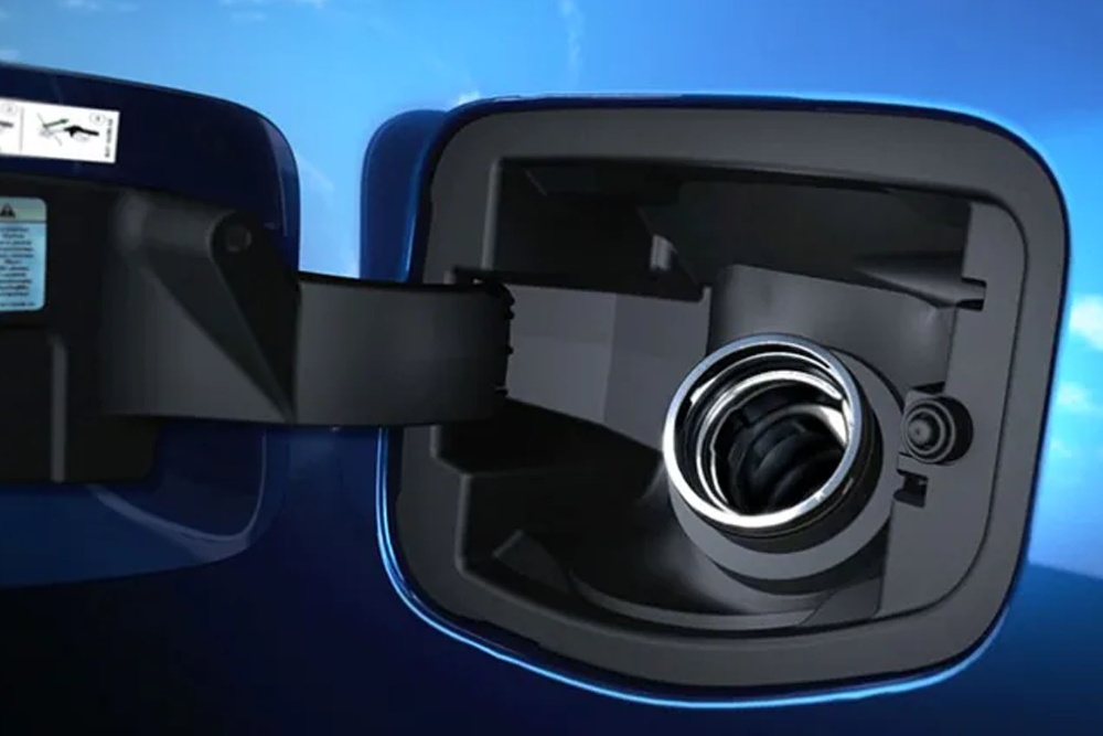 Close up of the Fuel filler on a blue Ford vehicle with fuel cap open.