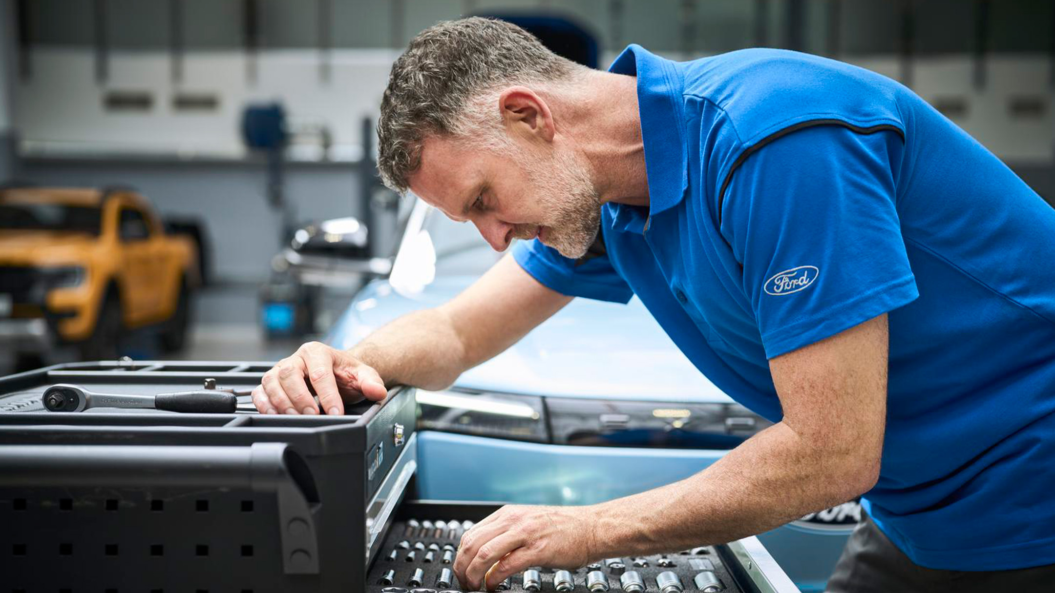 En Ford Pro-mekaniker sjekker en laptop under en Ford Service